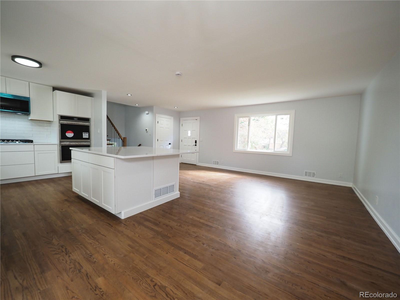6751 South Downing Circle West Centennial, CO 80122 - Photo 7 of 34 a view of a kitchen with stove and wooden floor