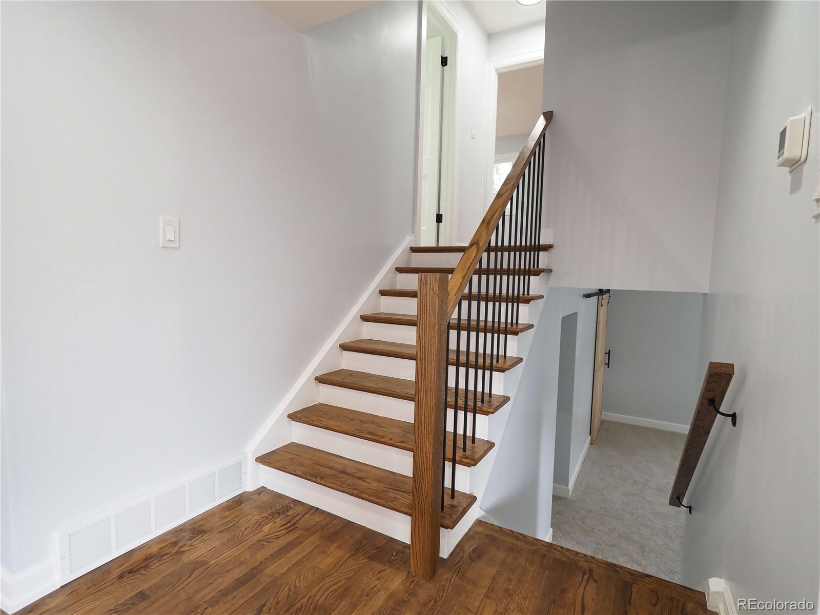 6751 South Downing Circle West Centennial, CO 80122 - Photo 9 of 34 a view of entryway with wooden floor and stairs