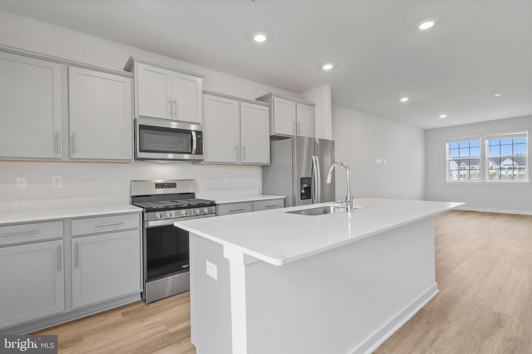 7520 Silver Thread Way Brandywine, MD 20613 - Photo 12 of 32 a kitchen with kitchen island a sink stainless steel appliances and cabinets