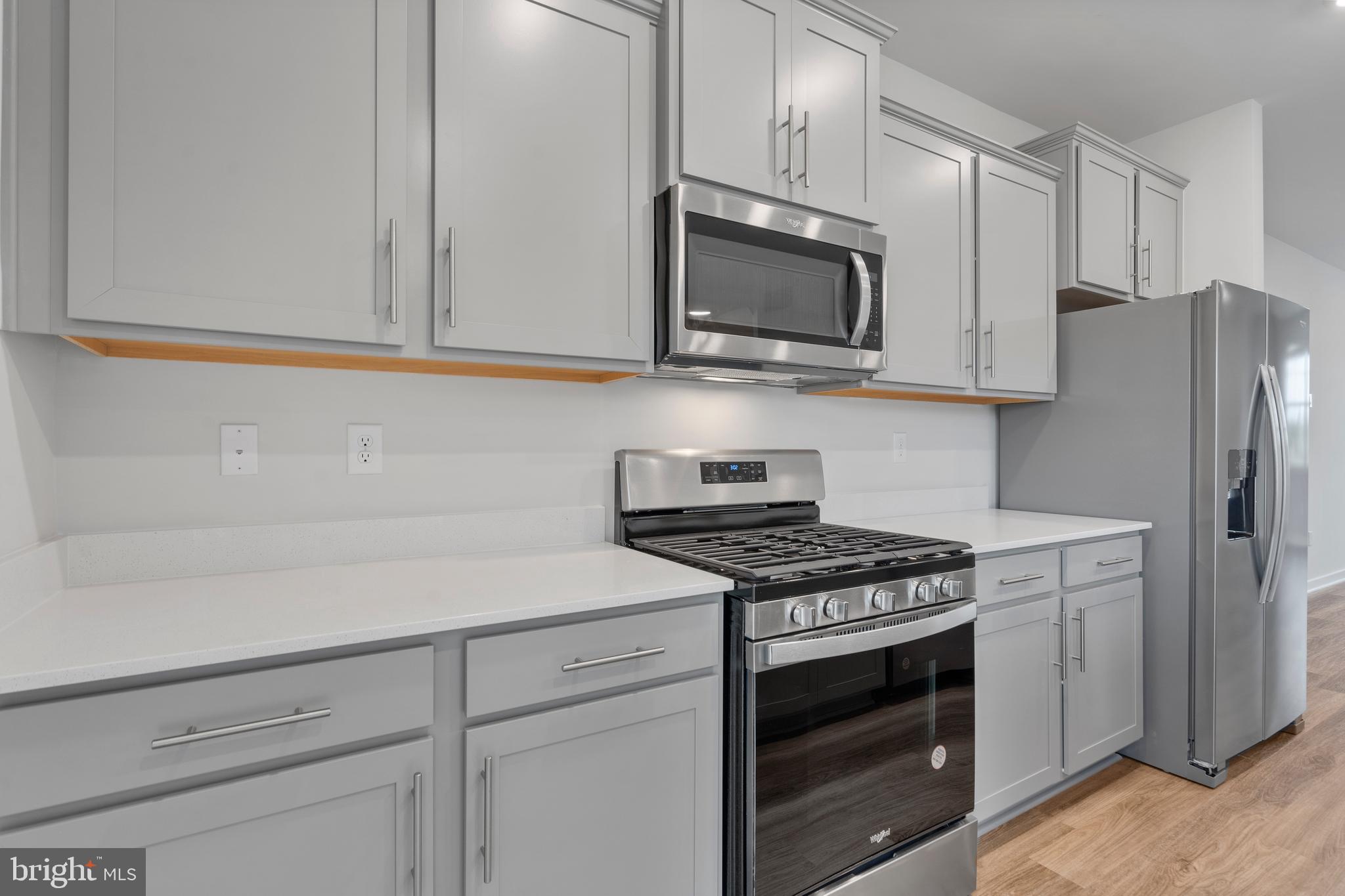 7520 Silver Thread Way Brandywine, MD 20613 - Photo 13 of 32 a kitchen with stainless steel appliances white cabinets and a stove a oven with wooden floor