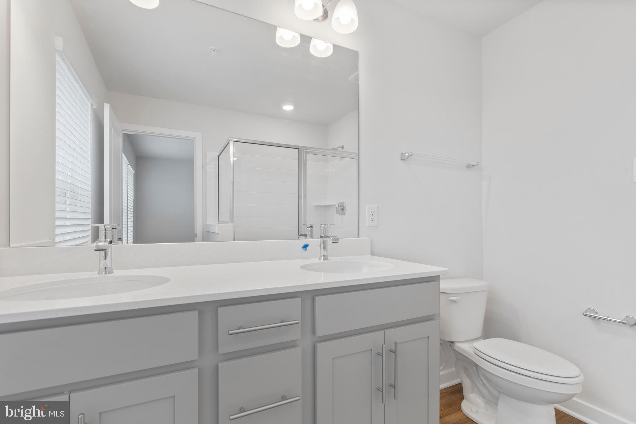 7520 Silver Thread Way Brandywine, MD 20613 - Photo 25 of 32 a bathroom with a sink a toilet and a mirror