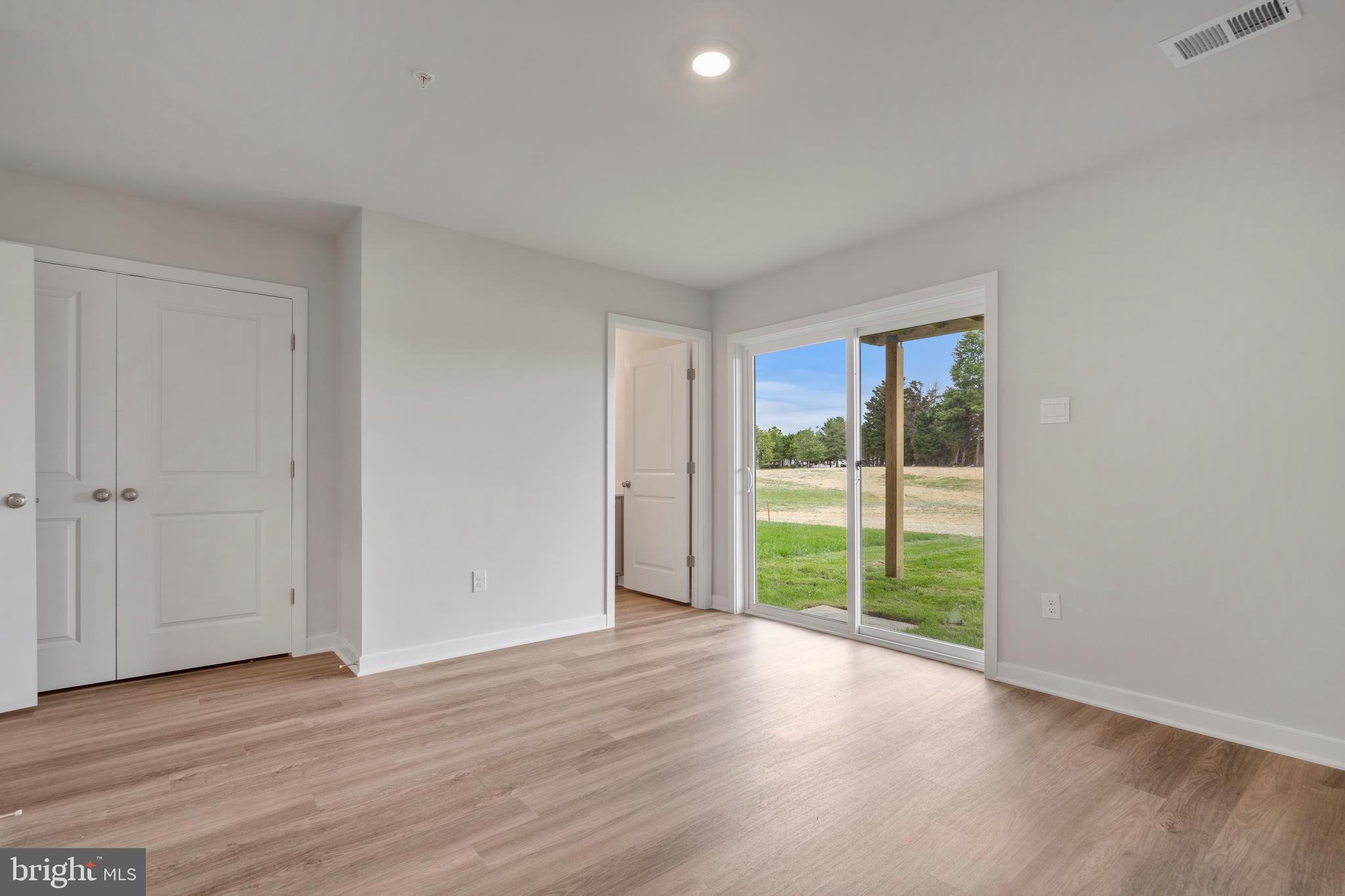 7520 Silver Thread Way Brandywine, MD 20613 - Photo 29 of 32 a view of an empty room with wooden floor and a window