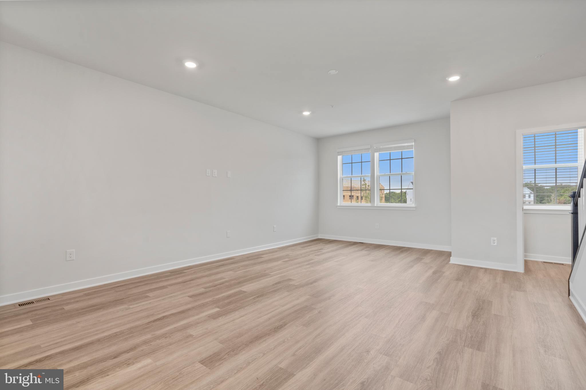 7520 Silver Thread Way Brandywine, MD 20613 - Photo 4 of 32 a view of an empty room with wooden floor and a window