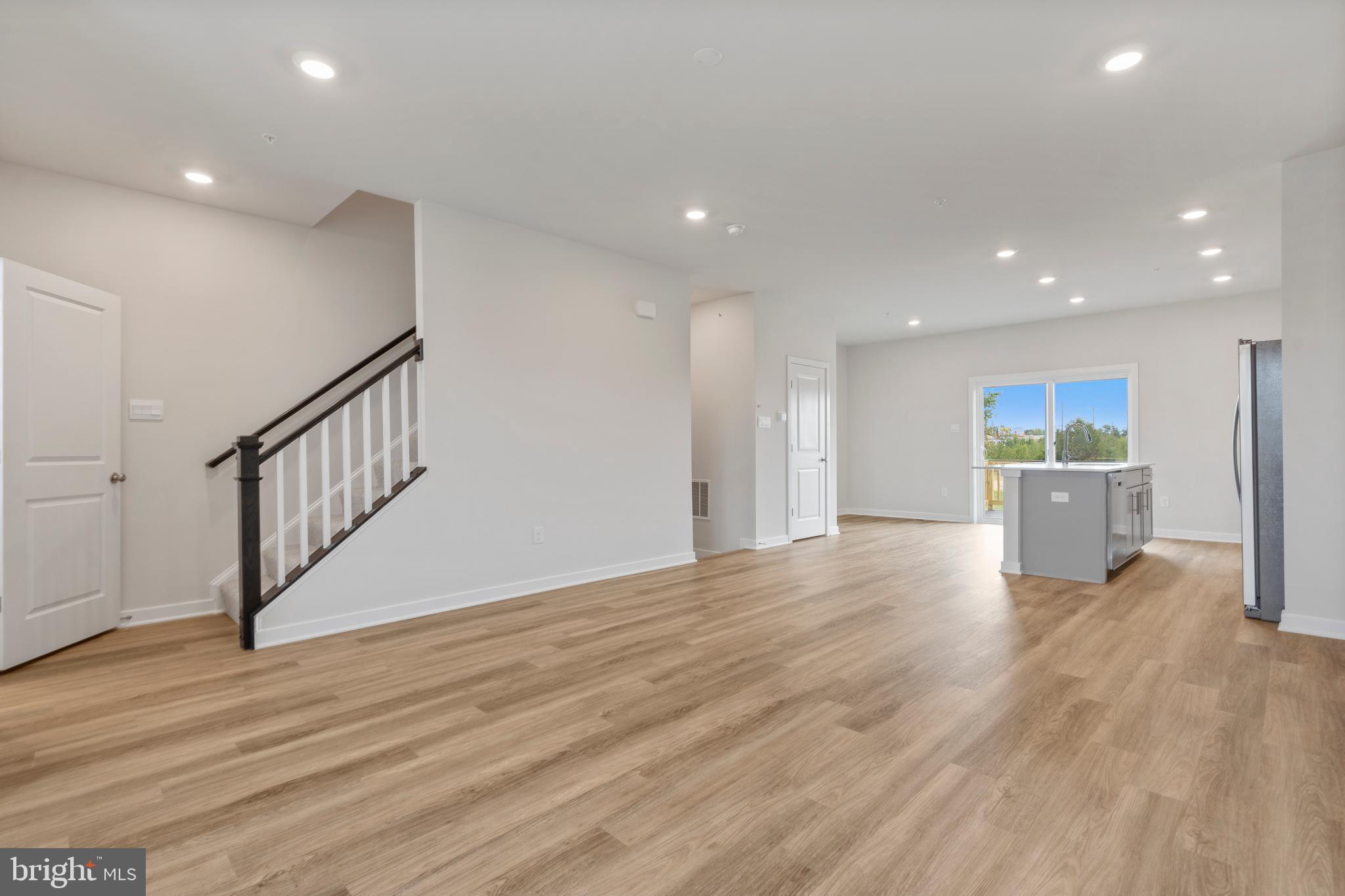 7520 Silver Thread Way Brandywine, MD 20613 - Photo 6 of 32 a view of an empty room with wooden floor kitchen view and a window