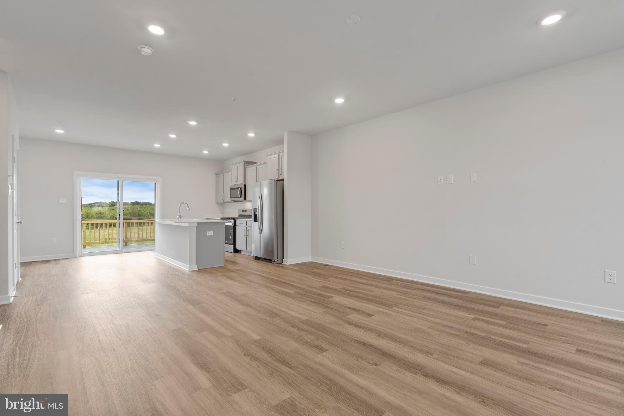 7520 Silver Thread Way Brandywine, MD 20613 - Photo 7 of 32 a view of an empty room with wooden floor and kitchen