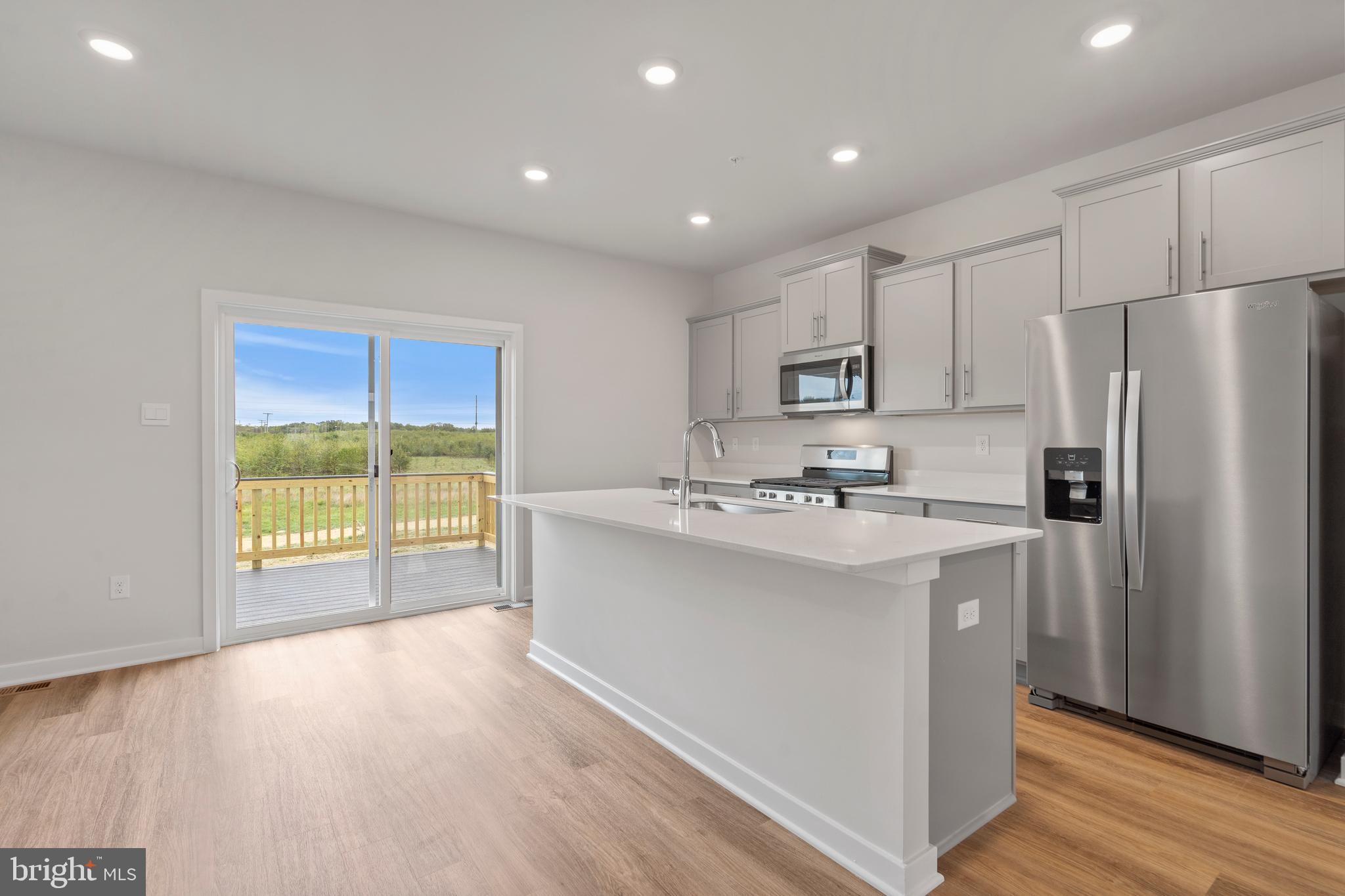7520 Silver Thread Way Brandywine, MD 20613 - Photo 9 of 32 a kitchen with kitchen island a sink appliances and cabinets