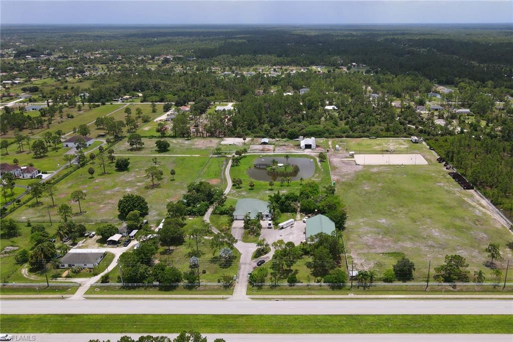 2400 Oil Well Road Naples, FL 34120 - Photo 19 of 35 an aerial view of residential houses with outdoor space and trees