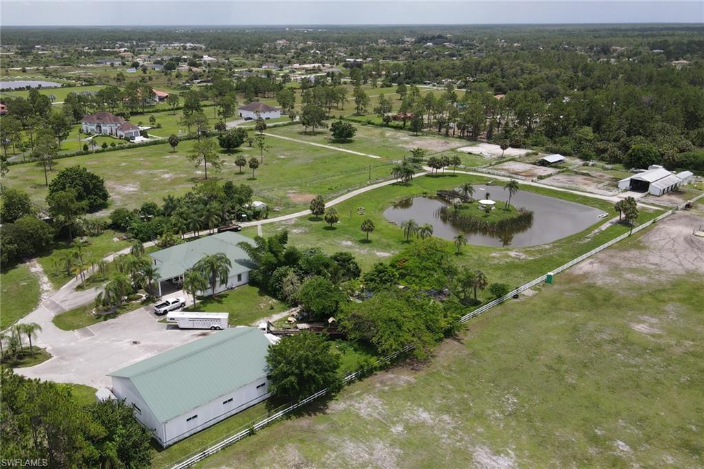 2400 Oil Well Road Naples, FL 34120 - Photo 21 of 35 an aerial view of residential houses with outdoor space and lake view