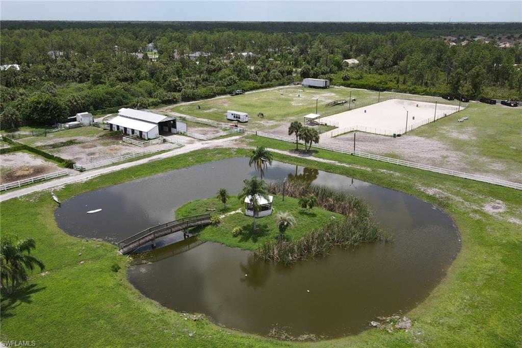 2400 Oil Well Road Naples, FL 34120 - Photo 25 of 35 a view of a lake with a yard