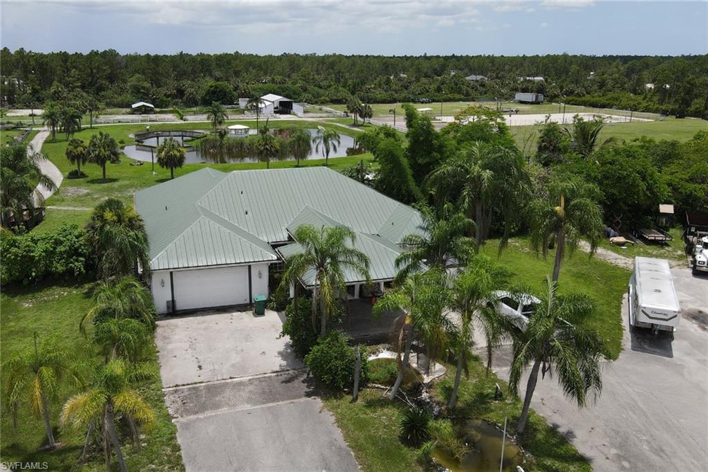 2400 Oil Well Road Naples, FL 34120 - Photo 29 of 35 an aerial view of residential houses with outdoor space and trees