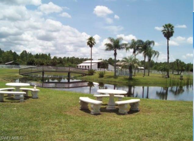 2400 Oil Well Road Naples, FL 34120 - Photo 10 of 35 a view of a lake with a table and chairs
