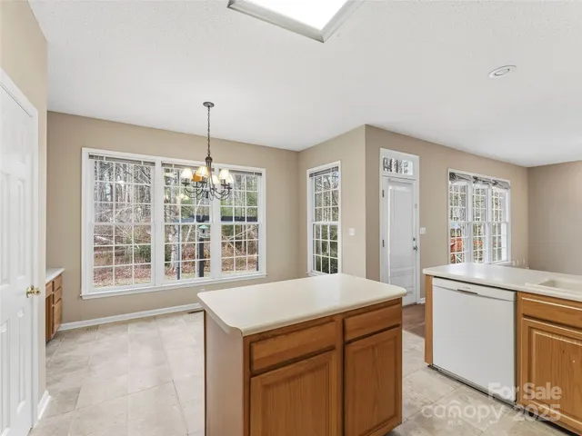 a kitchen with a stove sink and cabinets