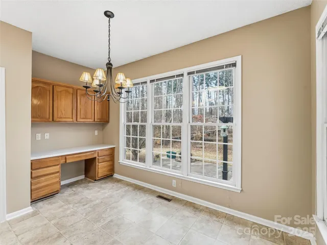 a kitchen with a refrigerator a stove top oven a sink dishwasher and wooden cabinets