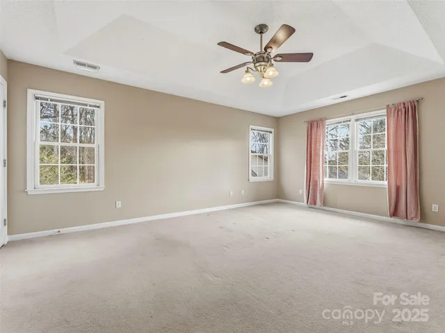 a view of a livingroom with a ceiling fan with window