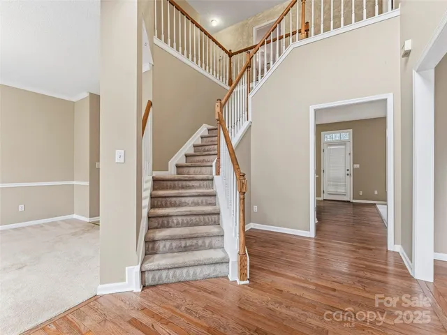 a view of entryway and hall with wooden floor