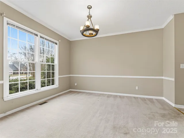a view of an empty room with windows