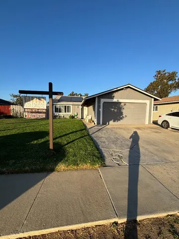 a view of a house with backyard porch and sitting area