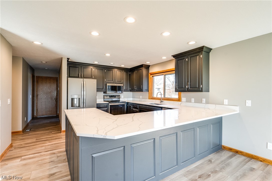 2949 Mill Ridge Circle Northwest Canton, OH 44708 - Photo 11 of 29 Updated kitchen with large eating bar, stainless appliances, and quartz counters