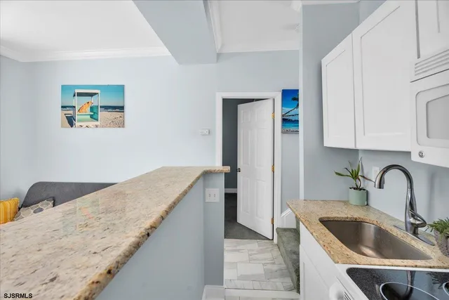 a kitchen with a sink and a refrigerator