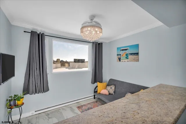 a view of dining room with wooden floor and a chandelier