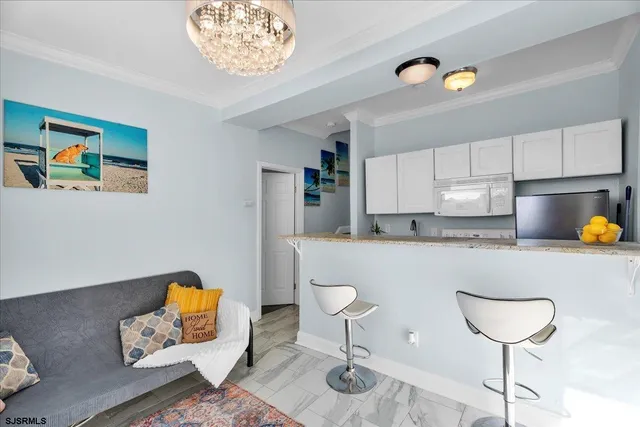 a kitchen with a table chairs and a living room