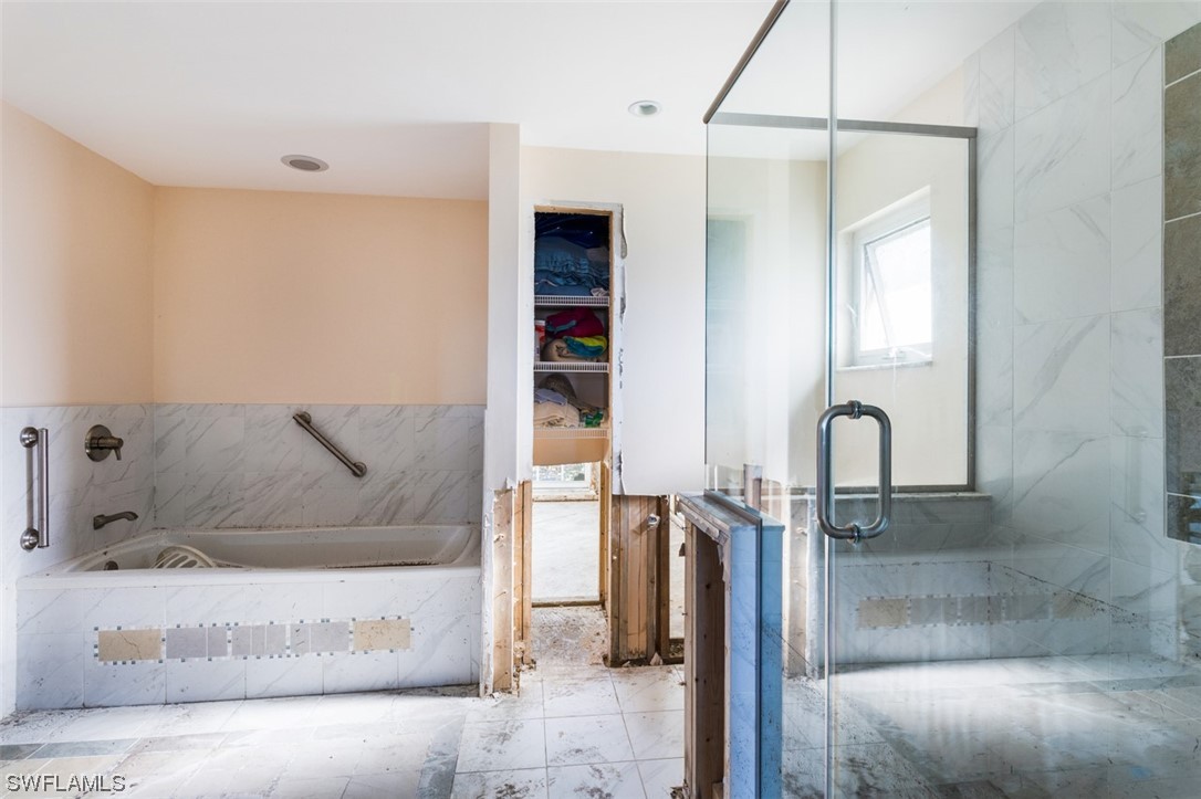 951 Sand Castle Road Sanibel, FL 33957 - Photo 22 of 27 a bathroom with a tub and a shower