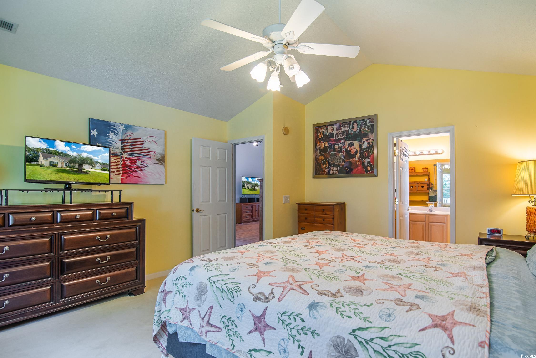 1052 Vestry Drive Murrells Inlet, SC 29576 - Photo 15 of 40 Bedroom featuring carpet flooring, lofted ceiling, ceiling fan, and ensuite bath