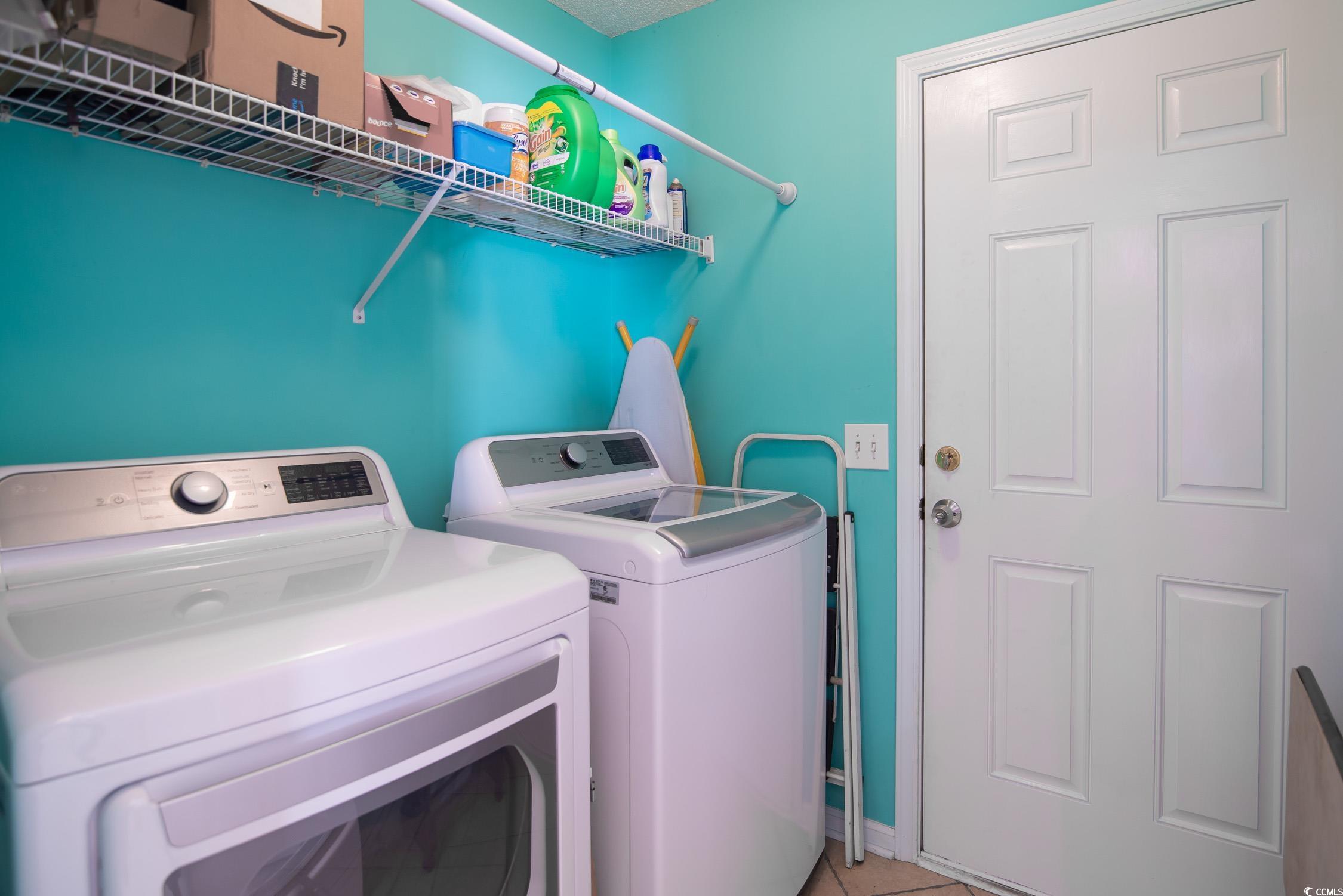 1052 Vestry Drive Murrells Inlet, SC 29576 - Photo 18 of 40 Laundry area with washing machine and clothes dryer and light tile patterned floors