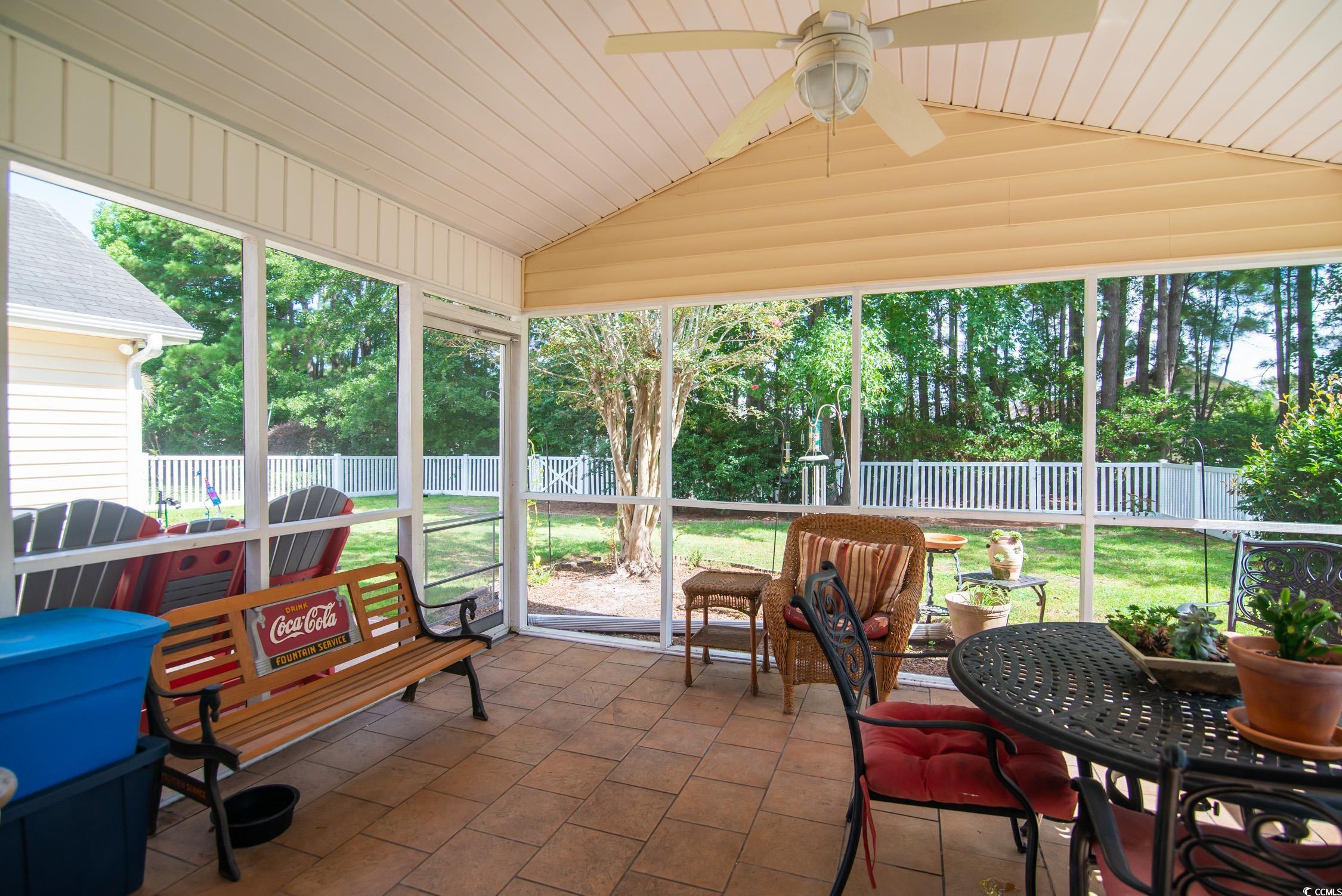 1052 Vestry Drive Murrells Inlet, SC 29576 - Photo 25 of 40 Sunroom featuring vaulted ceiling, ceiling fan, and outdoor dining space