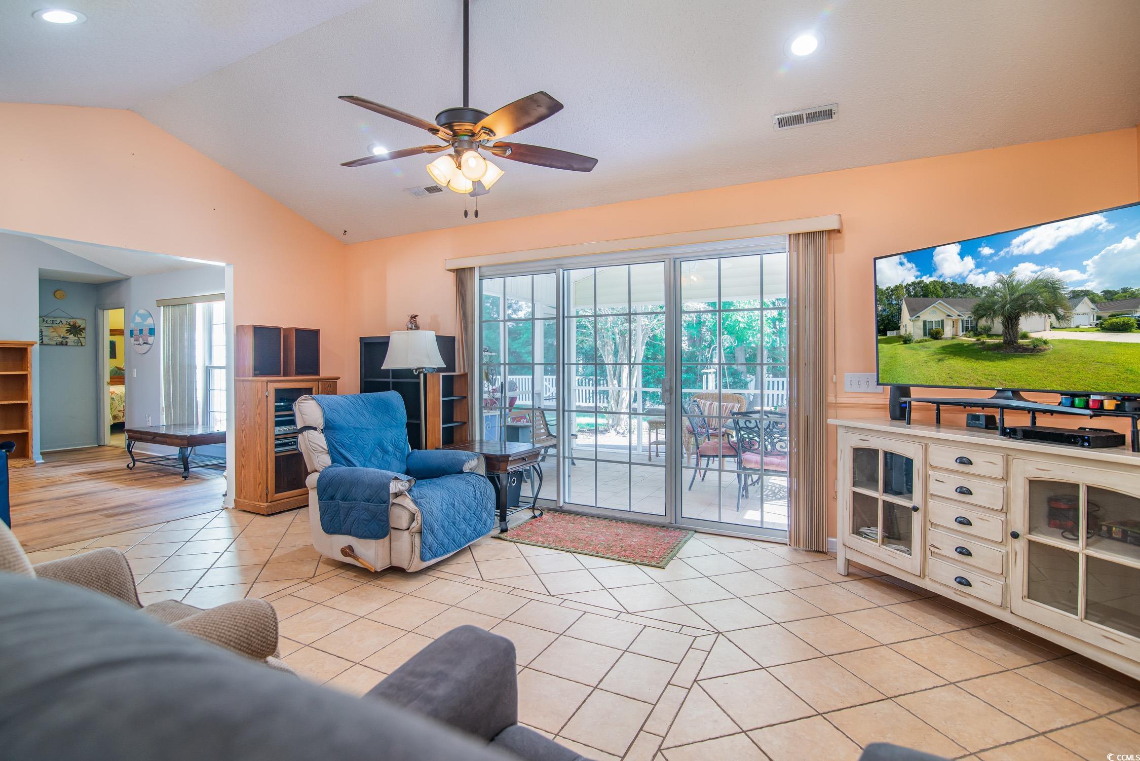1052 Vestry Drive Murrells Inlet, SC 29576 - Photo 27 of 40 Living area with vaulted ceiling, a ceiling fan, recessed lighting, and light tile patterned flooring