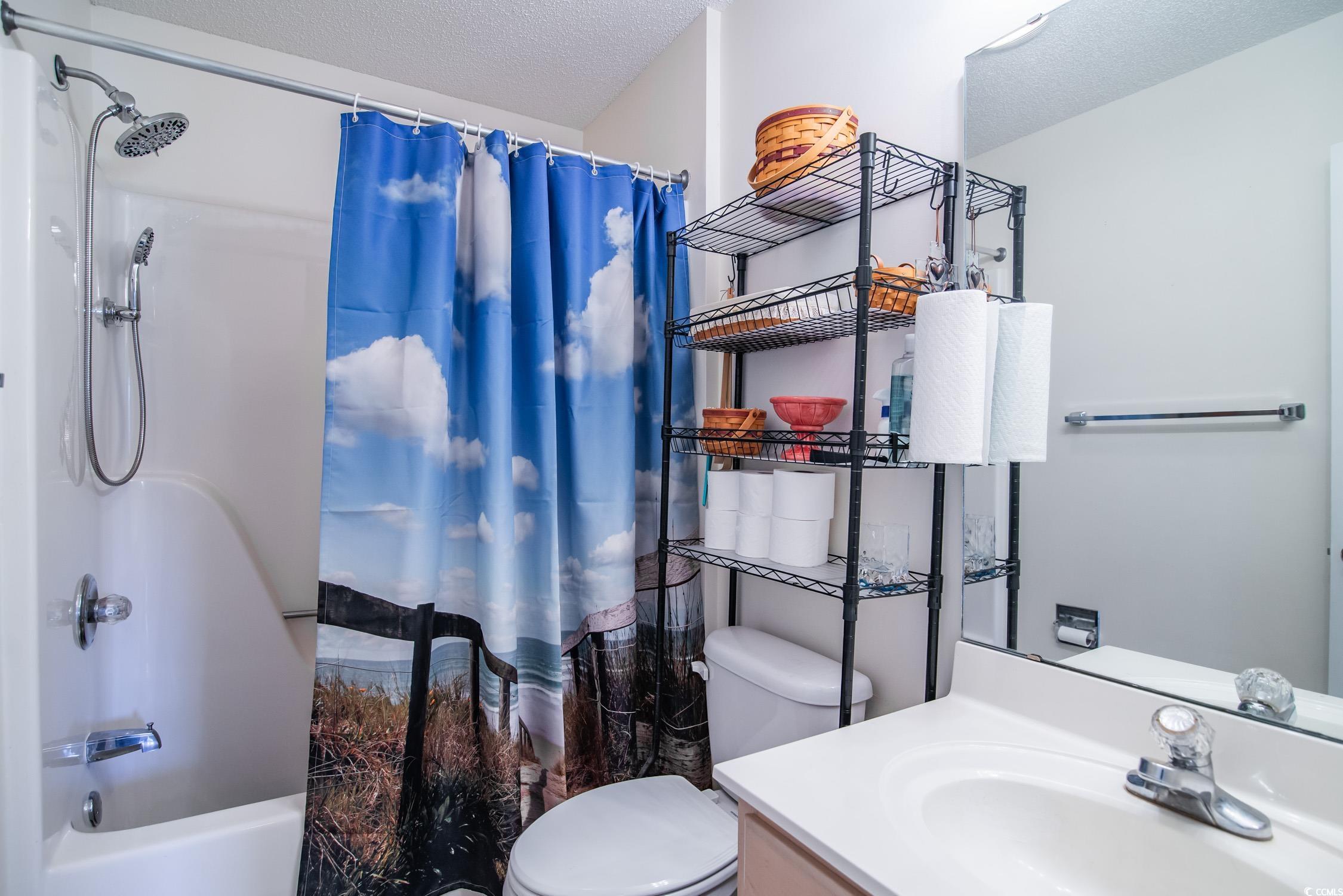 1052 Vestry Drive Murrells Inlet, SC 29576 - Photo 30 of 40 Bathroom with shower / bathtub combination with curtain, vanity, and a textured ceiling