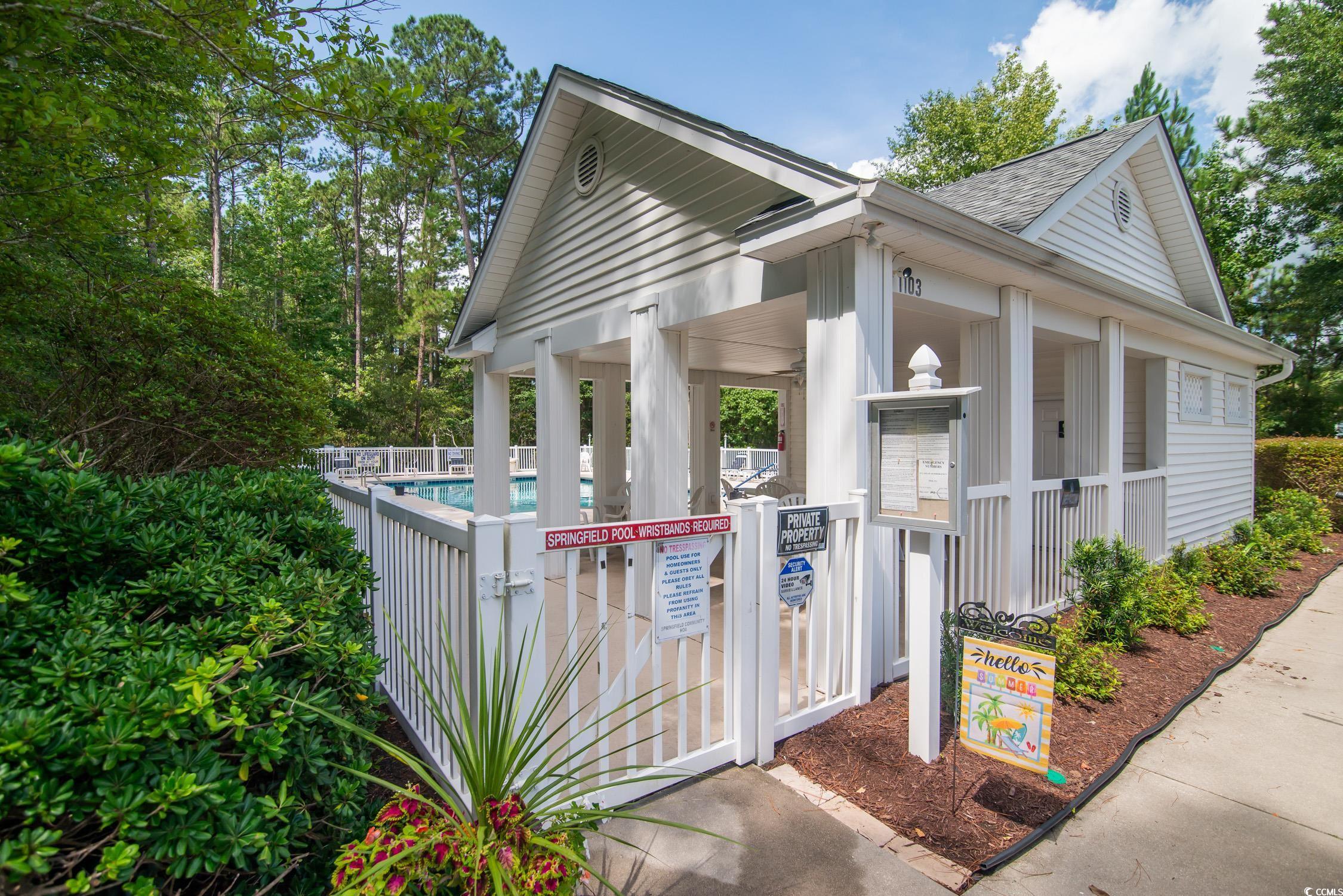 1052 Vestry Drive Murrells Inlet, SC 29576 - Photo 33 of 40 View of property exterior featuring a community pool, a shingled roof, and a porch