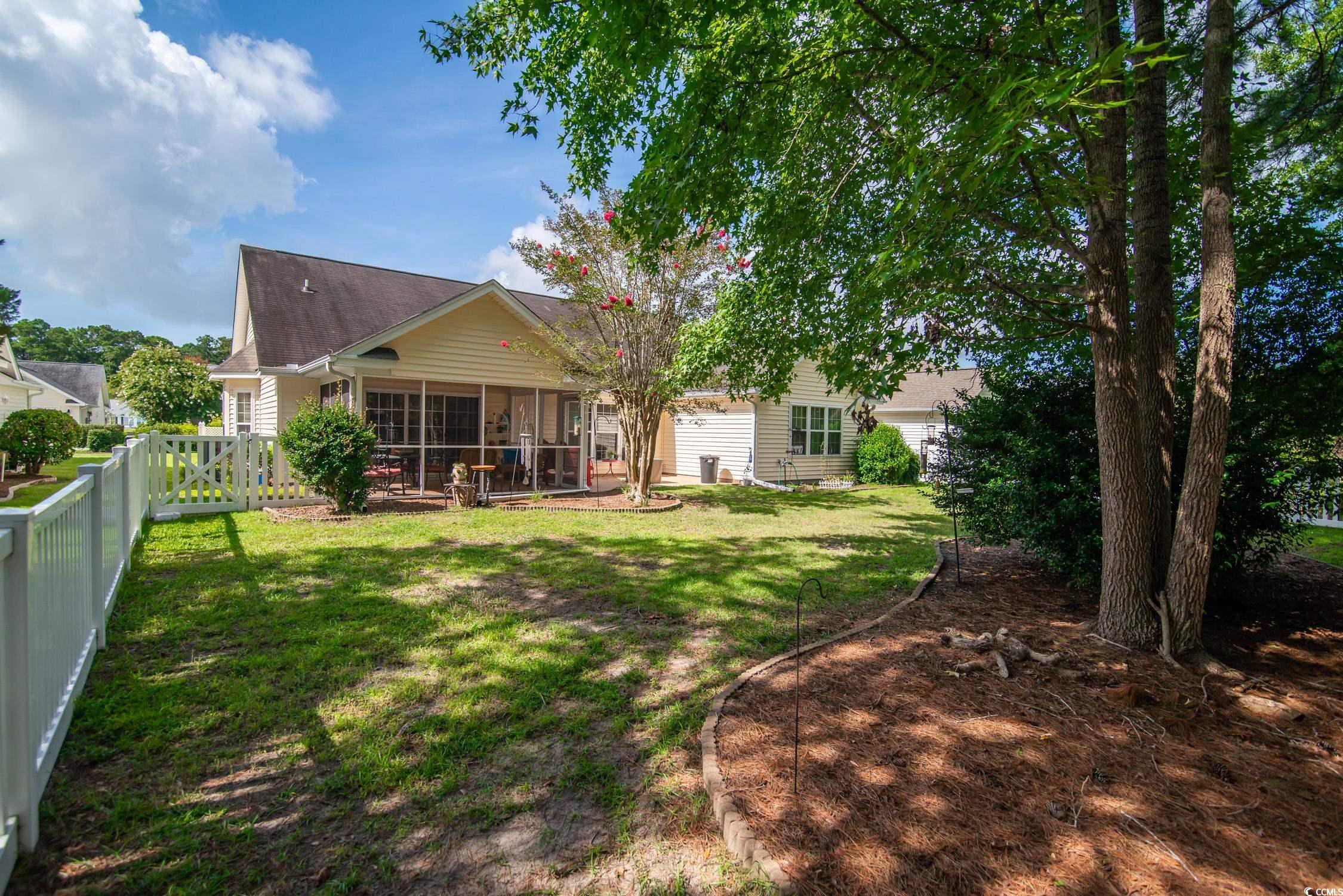 1052 Vestry Drive Murrells Inlet, SC 29576 - Photo 4 of 40 Rear view of property featuring a sunroom, a fenced backyard, and a shingled roof