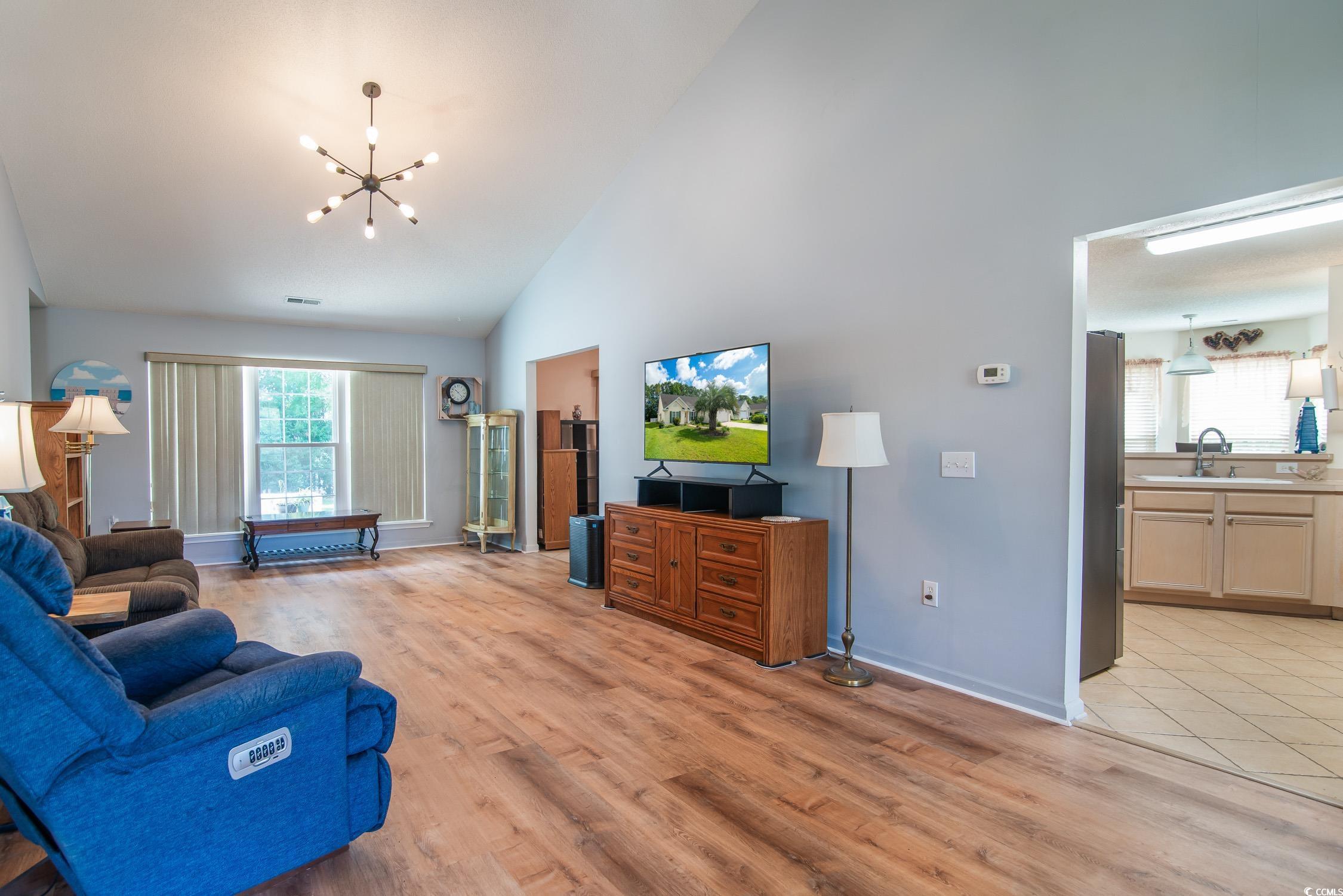 1052 Vestry Drive Murrells Inlet, SC 29576 - Photo 6 of 40 Living room with a chandelier, light wood-style flooring, and high vaulted ceiling