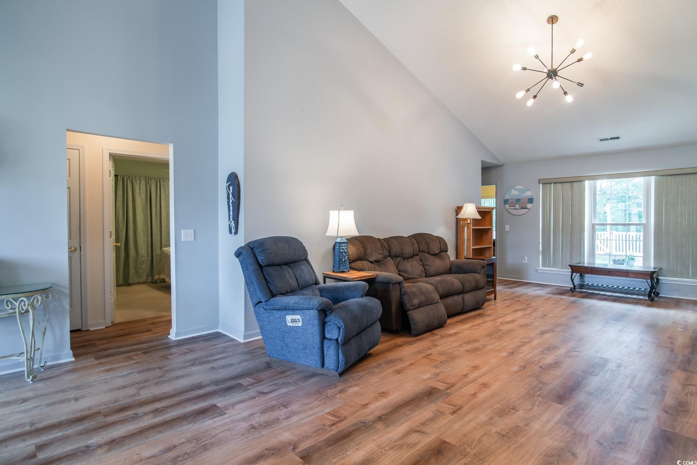 1052 Vestry Drive Murrells Inlet, SC 29576 - Photo 7 of 40 Living area with high vaulted ceiling, a chandelier, and wood finished floors