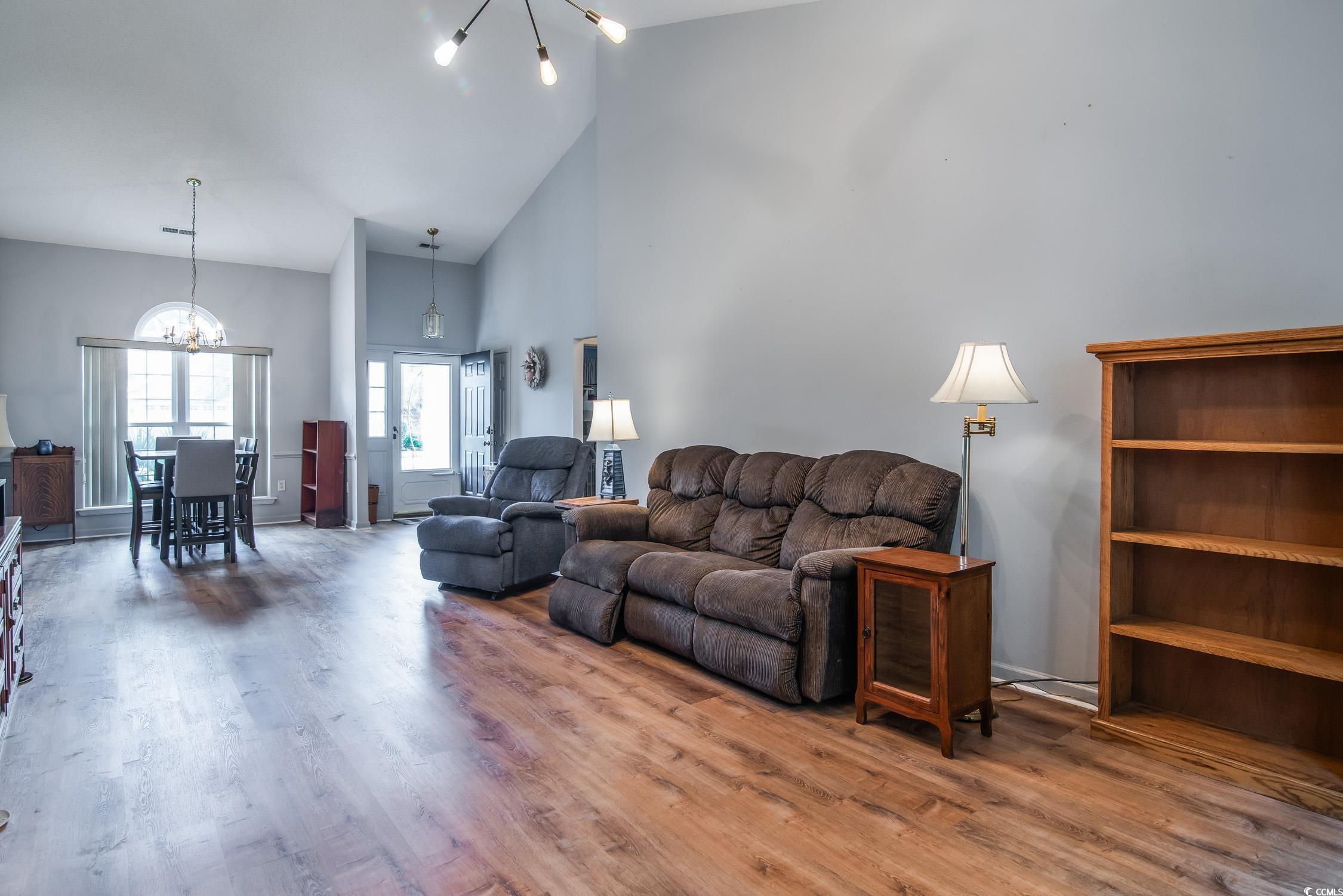 1052 Vestry Drive Murrells Inlet, SC 29576 - Photo 8 of 40 Living room with a chandelier, high vaulted ceiling, and wood finished floors