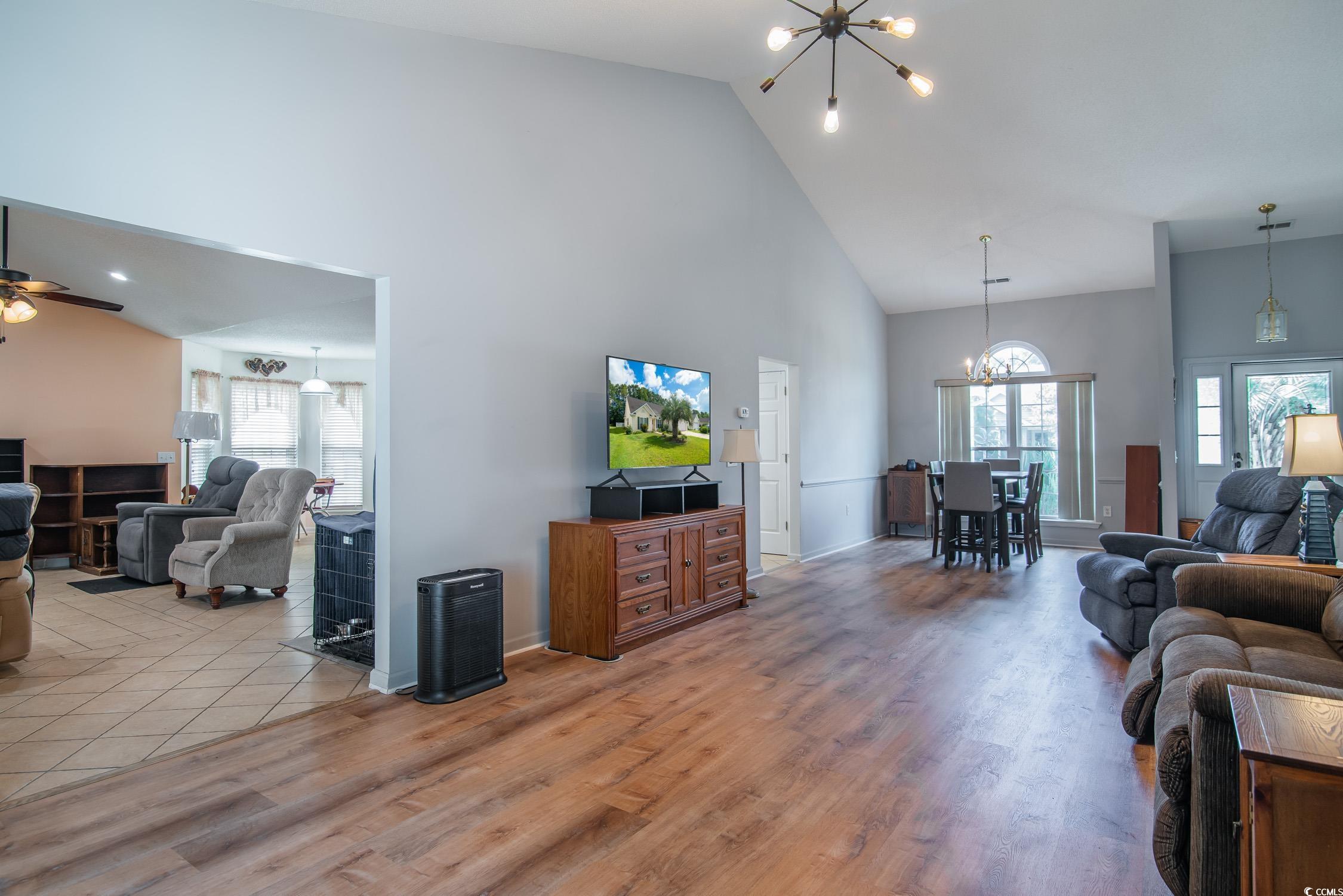 1052 Vestry Drive Murrells Inlet, SC 29576 - Photo 9 of 40 Living area with high vaulted ceiling, a chandelier, wood finished floors, and a ceiling fan