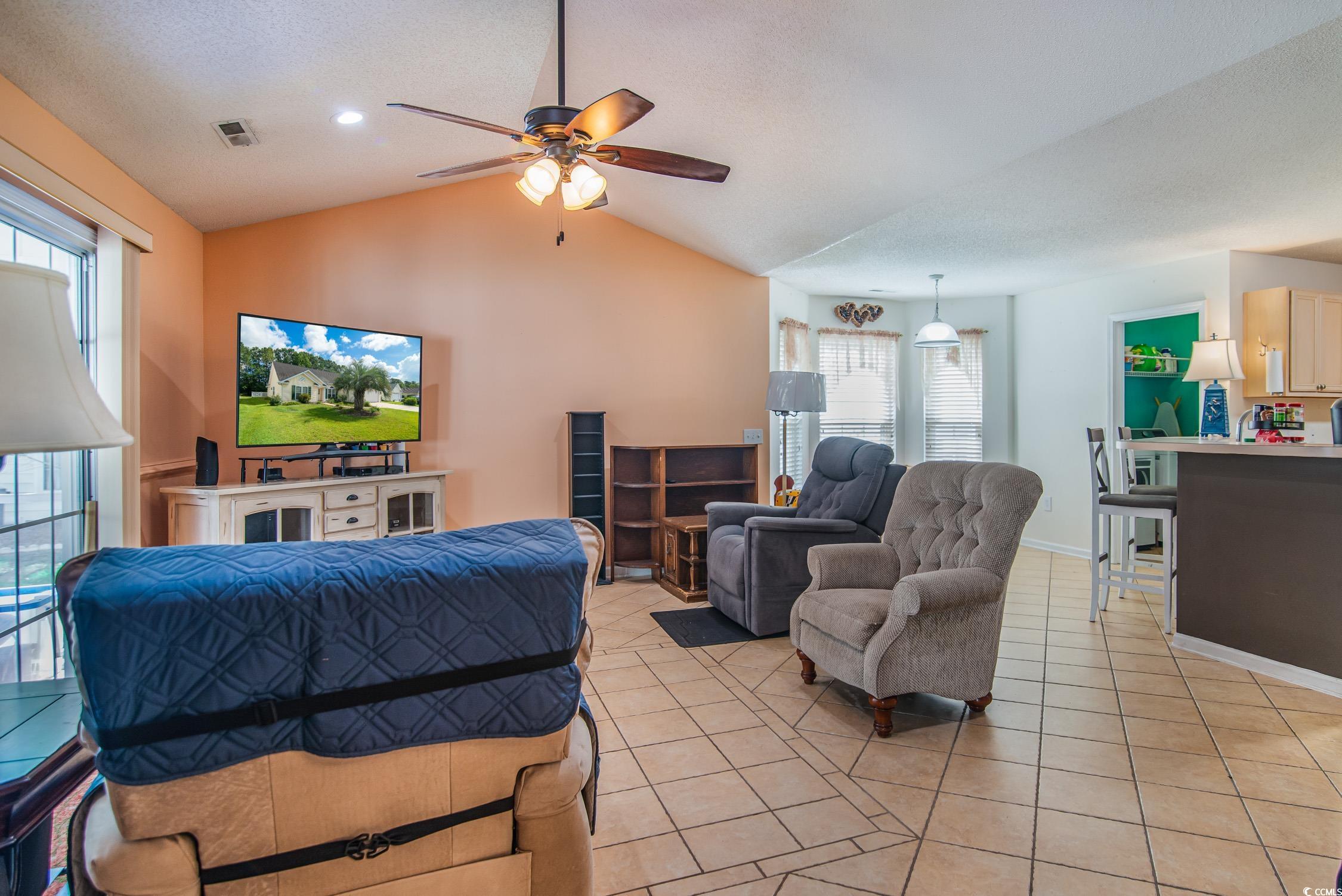 1052 Vestry Drive Murrells Inlet, SC 29576 - Photo 10 of 40 Living room with light tile patterned flooring, healthy amount of natural light, a ceiling fan, vaulted ceiling, and recessed lighting