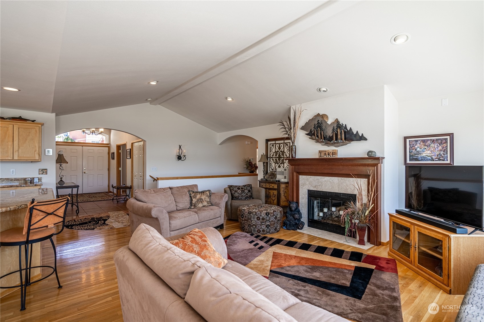 114 Long Drive Chelan, WA 98816 - Photo 11 of 38 a living room with furniture a flat screen tv and a fireplace
