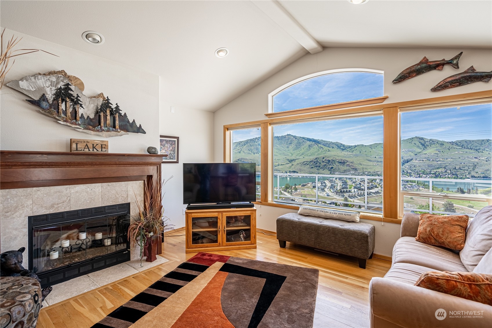 114 Long Drive Chelan, WA 98816 - Photo 12 of 38 a living room with furniture a flat screen tv and a fireplace