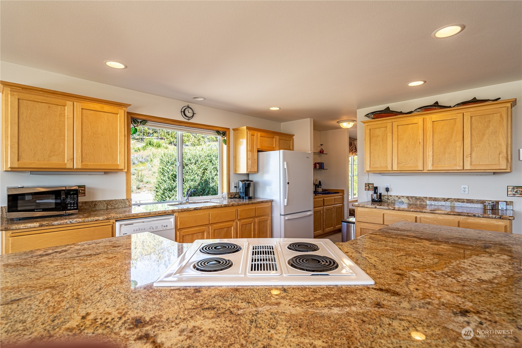 114 Long Drive Chelan, WA 98816 - Photo 18 of 38 a kitchen with stainless steel appliances granite countertop a stove a sink and a microwave