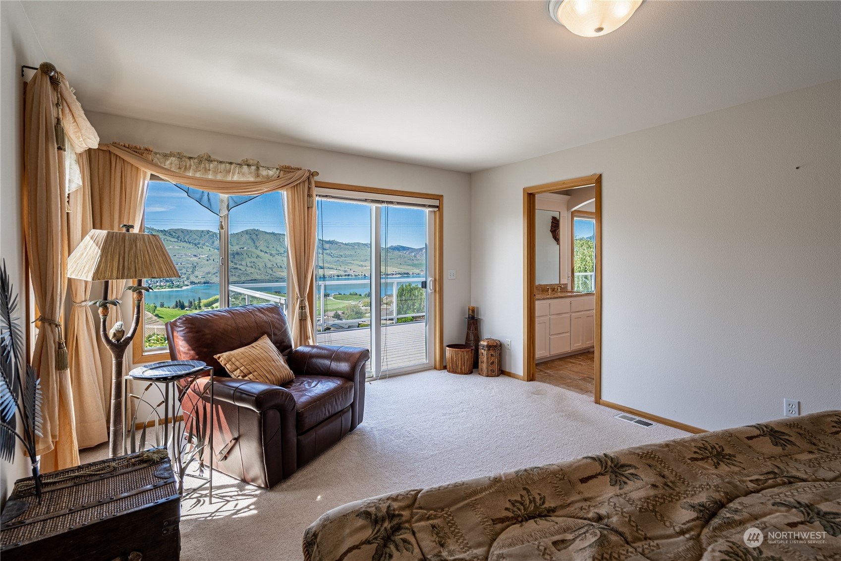 114 Long Drive Chelan, WA 98816 - Photo 22 of 38 a bedroom with a bed and large windows