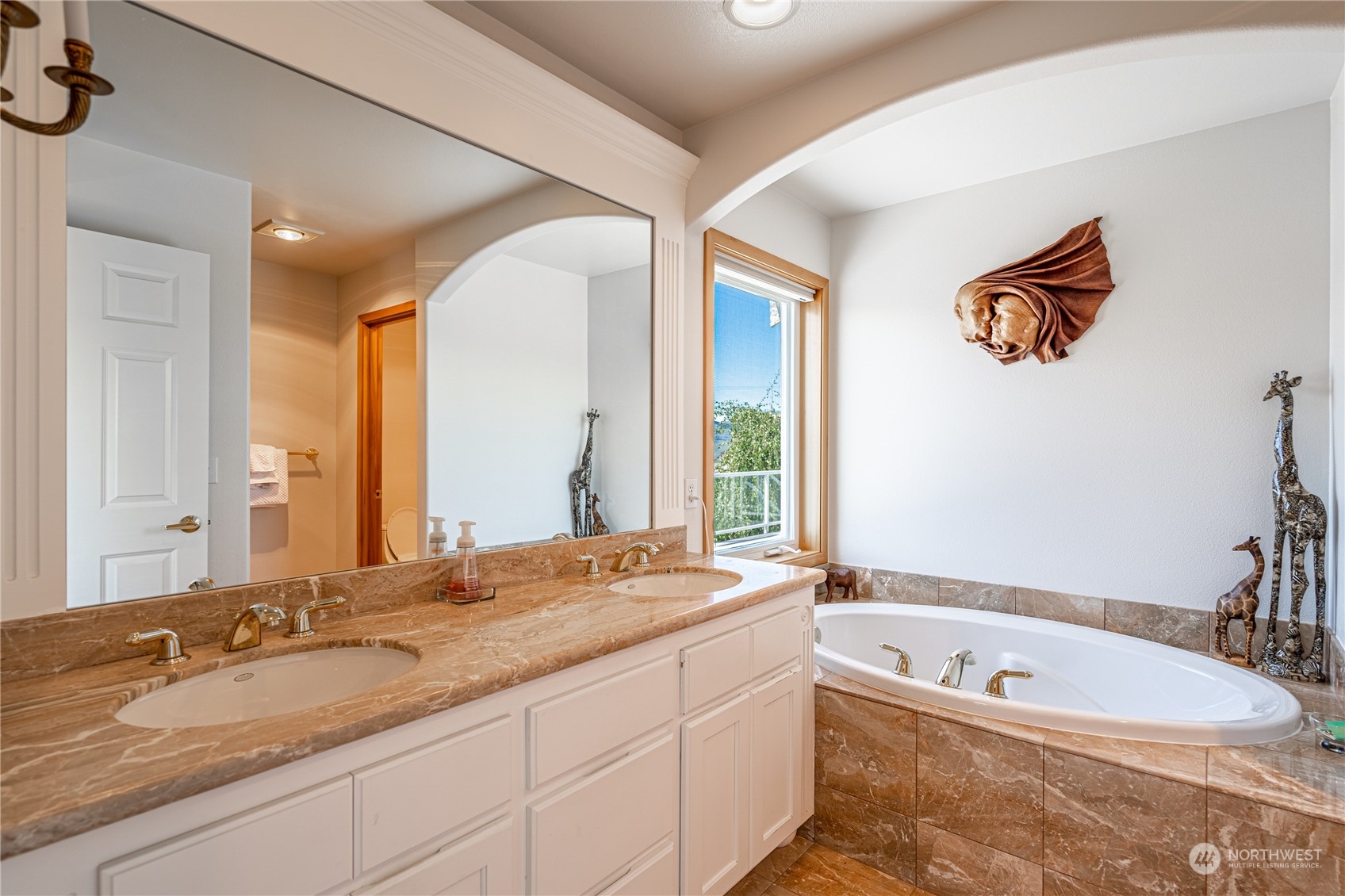 114 Long Drive Chelan, WA 98816 - Photo 23 of 38 a bathroom with a granite countertop tub a double vanity sink and a large mirror