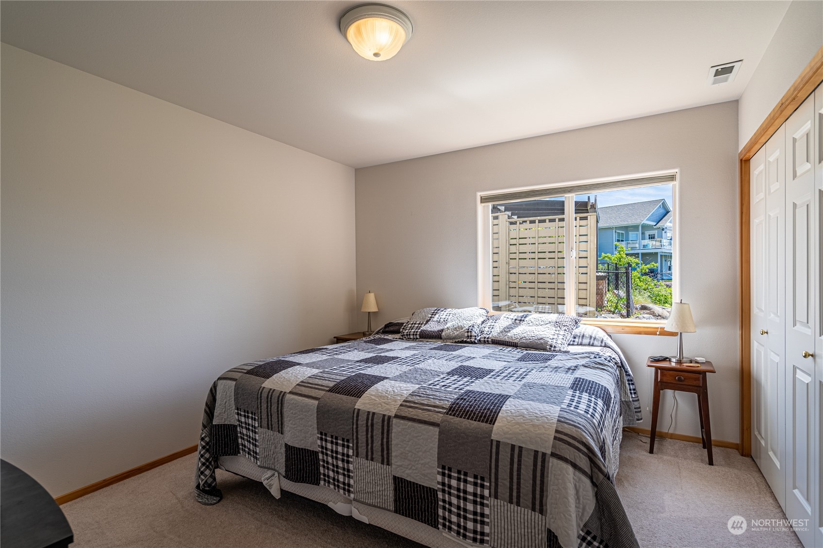 114 Long Drive Chelan, WA 98816 - Photo 27 of 38 a bedroom with a bed lamp and a window