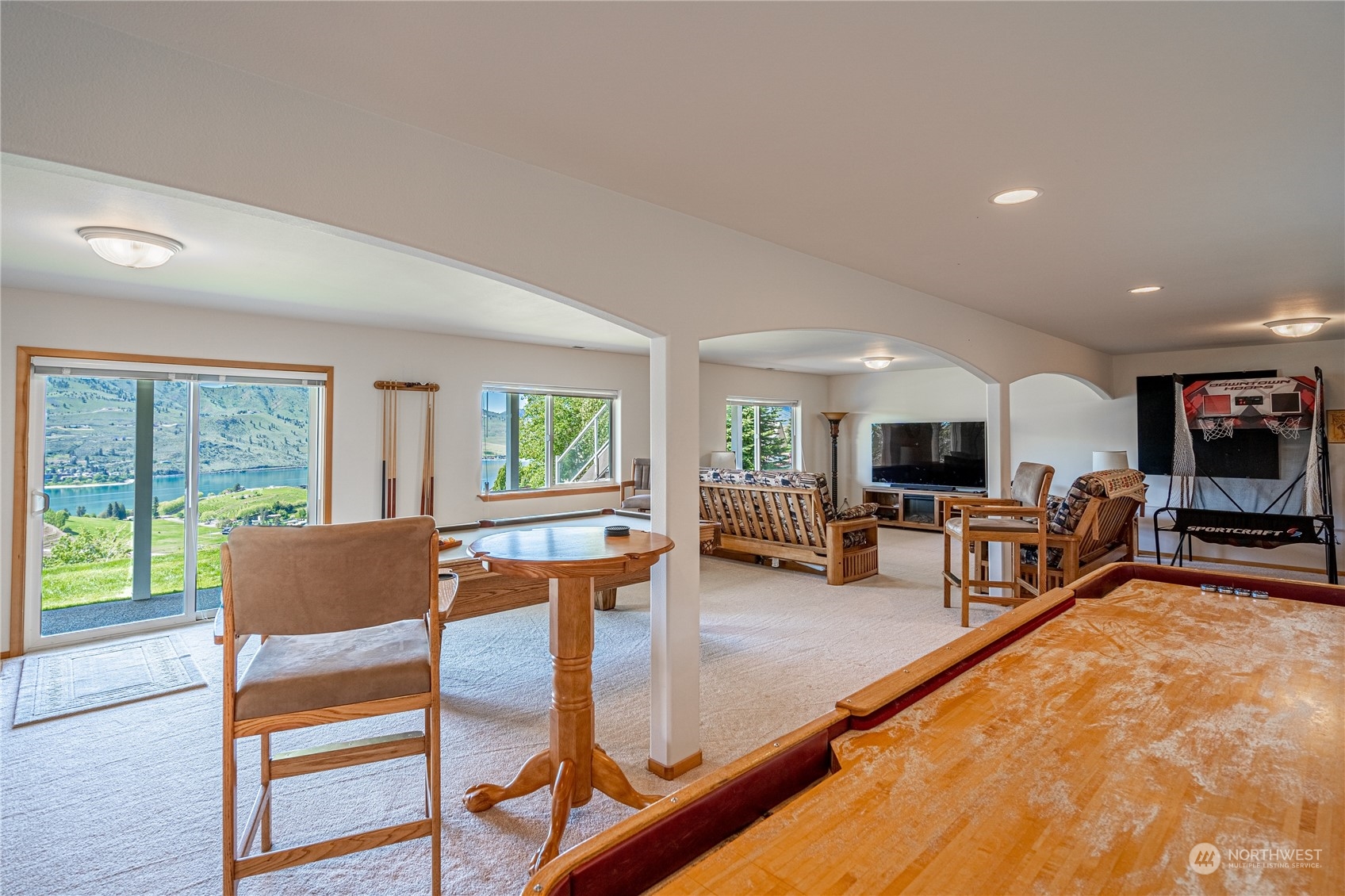 114 Long Drive Chelan, WA 98816 - Photo 31 of 38 a living room with furniture a flat screen tv and a large window