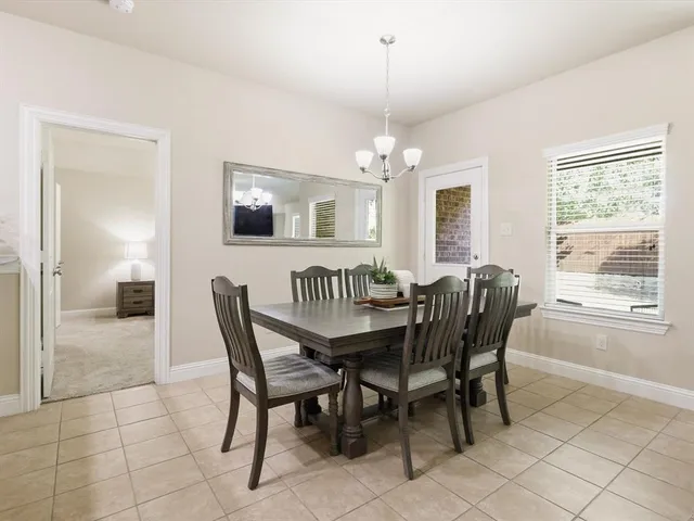 a view of a dining room with furniture and chandelier