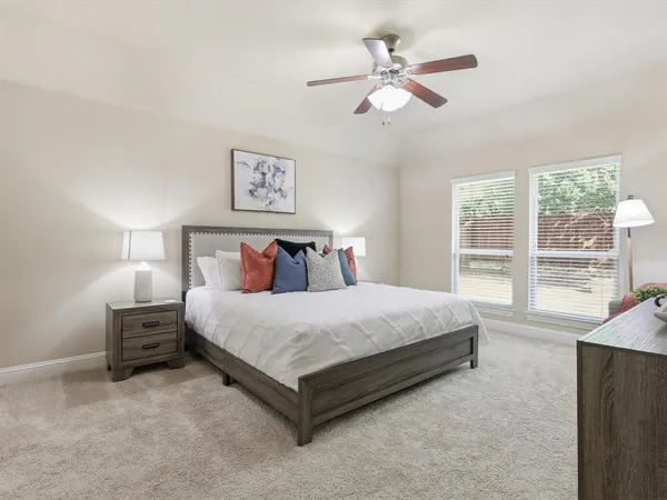 a bedroom with a large bed and a large window