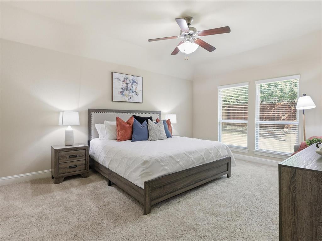 609 Racine Drive Oak Point, TX 75068 - Photo 14 of 30 a bedroom with a large bed and a large window