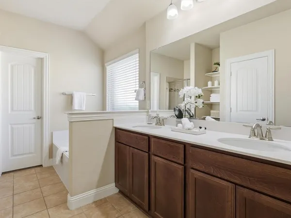 a bathroom with a double vanity sink and a mirror