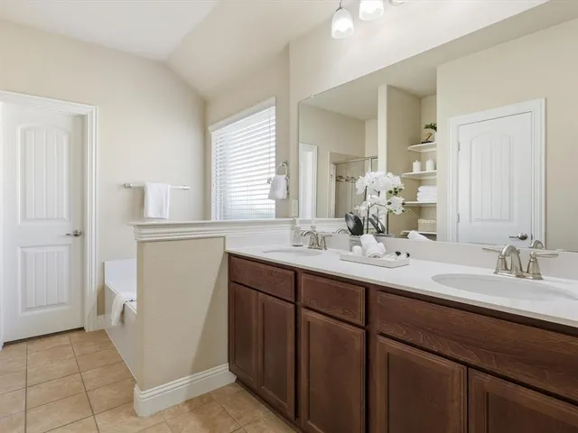 a bathroom with a double vanity sink and a mirror